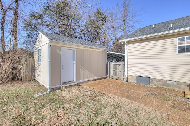 view of outdoor structure featuring a yard and a carport