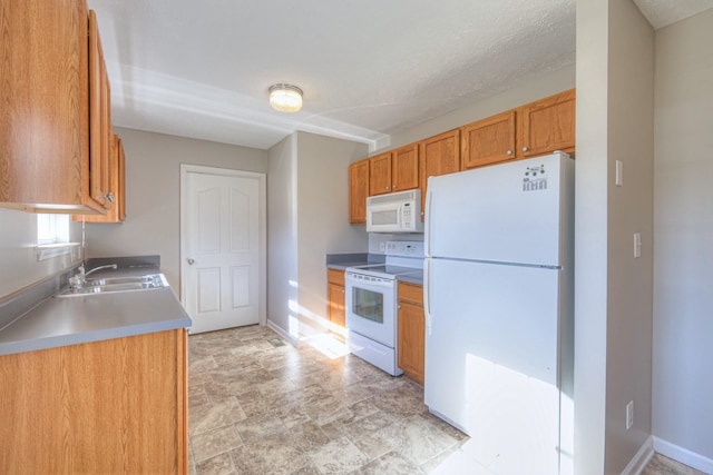 kitchen featuring sink and white appliances