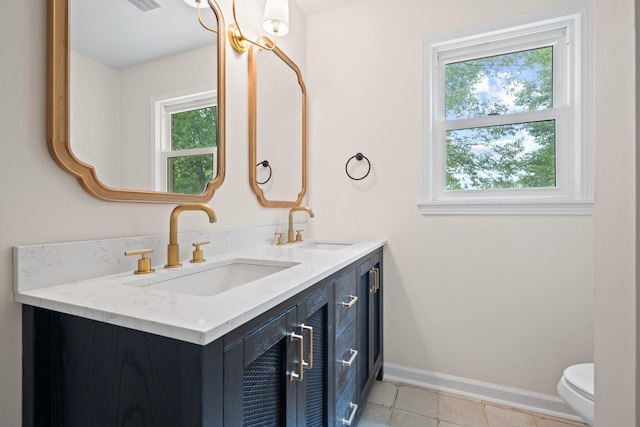 bathroom featuring toilet, tile patterned flooring, and vanity