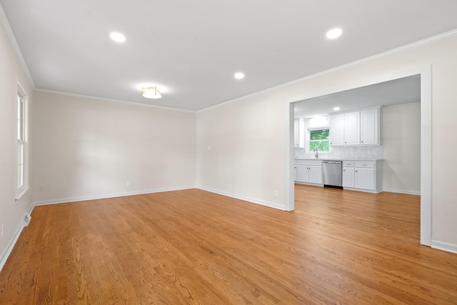 unfurnished living room featuring light wood-type flooring and crown molding