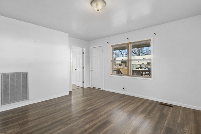 unfurnished room with dark hardwood / wood-style floors