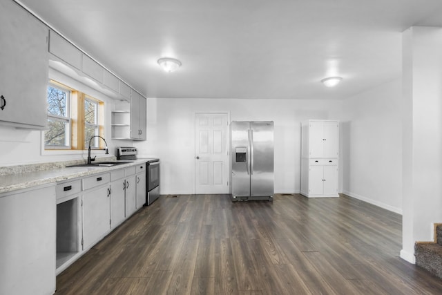 kitchen featuring appliances with stainless steel finishes, sink, and dark hardwood / wood-style floors