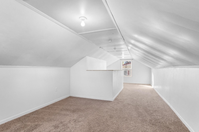 bonus room with carpet floors and lofted ceiling