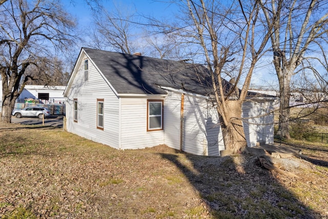 view of side of property with a lawn