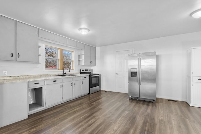 kitchen with appliances with stainless steel finishes, dark hardwood / wood-style floors, and sink