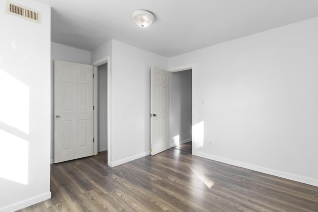 unfurnished bedroom with dark wood-type flooring