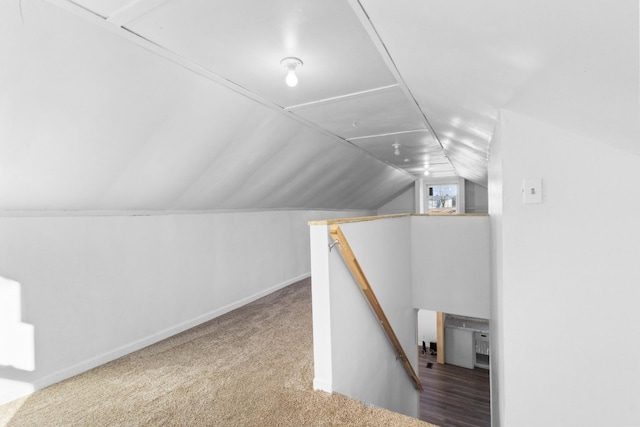 bonus room featuring lofted ceiling and carpet floors