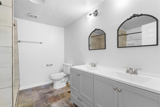 bathroom featuring toilet and vanity