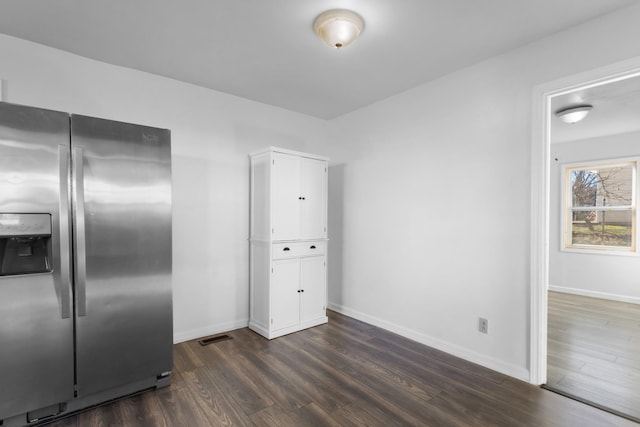 kitchen featuring white cabinets, stainless steel refrigerator with ice dispenser, and dark hardwood / wood-style flooring