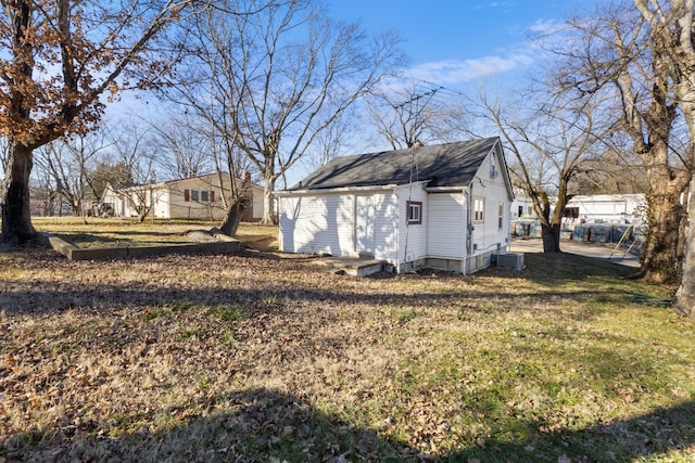 view of side of home with a lawn and central air condition unit