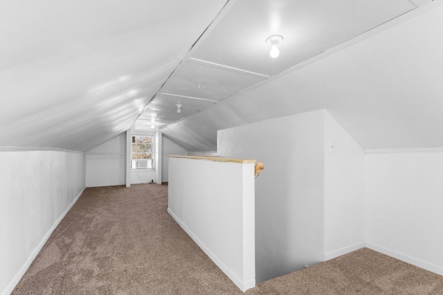 bonus room with cooling unit, lofted ceiling, and light colored carpet