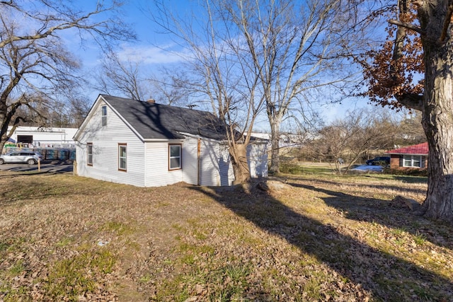 view of side of property with a yard