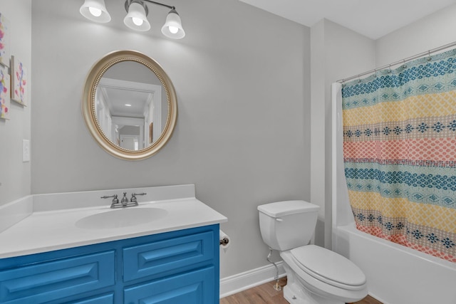 full bathroom with hardwood / wood-style floors, toilet, vanity, and shower / tub combo