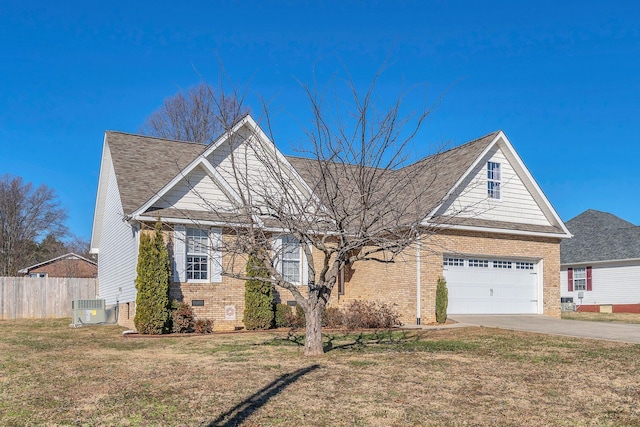 view of front facade with central AC unit, a garage, and a front yard