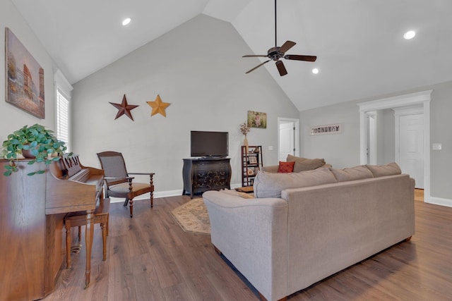 living room featuring ceiling fan, dark hardwood / wood-style floors, and high vaulted ceiling