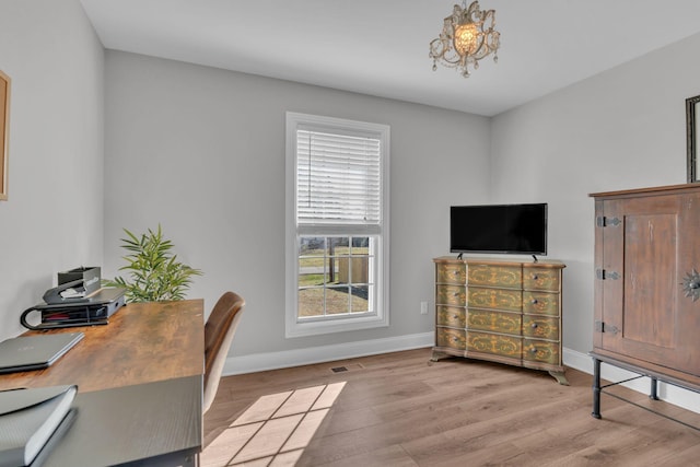 office area with a notable chandelier and light wood-type flooring