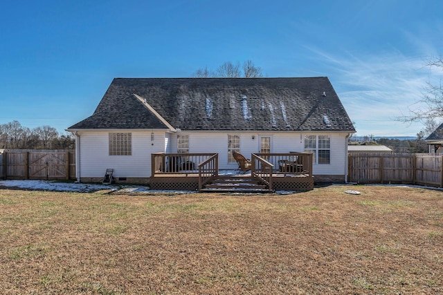 rear view of property featuring a deck and a lawn