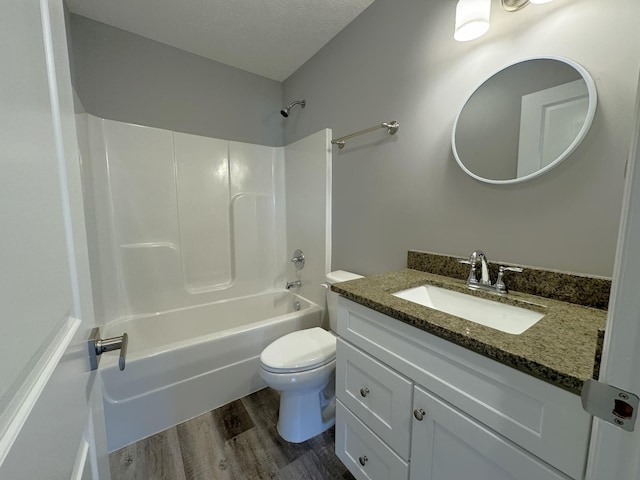 full bathroom with a textured ceiling, shower / tub combination, wood-type flooring, vanity, and toilet