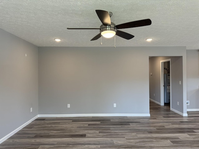 unfurnished room featuring ceiling fan, dark wood-type flooring, and a textured ceiling