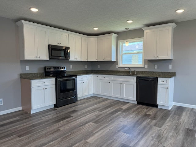 kitchen with sink, white cabinets, black dishwasher, and stainless steel electric range oven