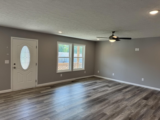 entrance foyer with ceiling fan, dark hardwood / wood-style flooring, and a textured ceiling