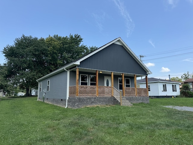 view of front of property with a front yard and covered porch