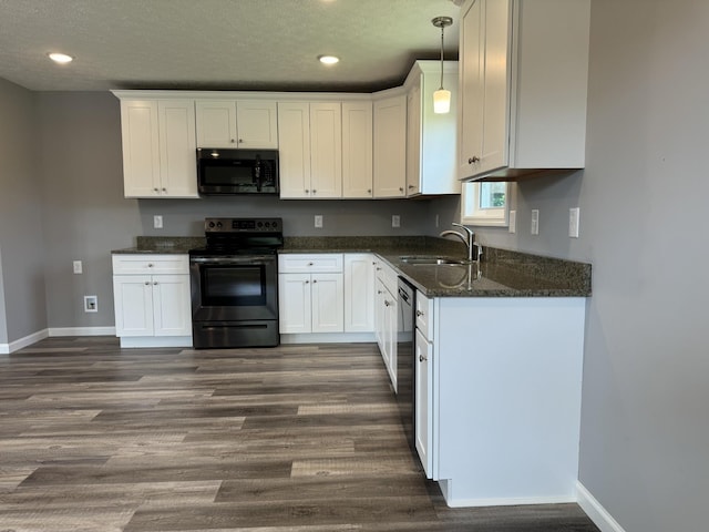 kitchen with decorative light fixtures, dark hardwood / wood-style flooring, stainless steel electric range, white cabinets, and sink