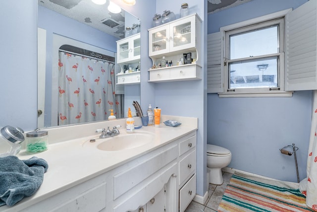 bathroom featuring toilet, curtained shower, and vanity