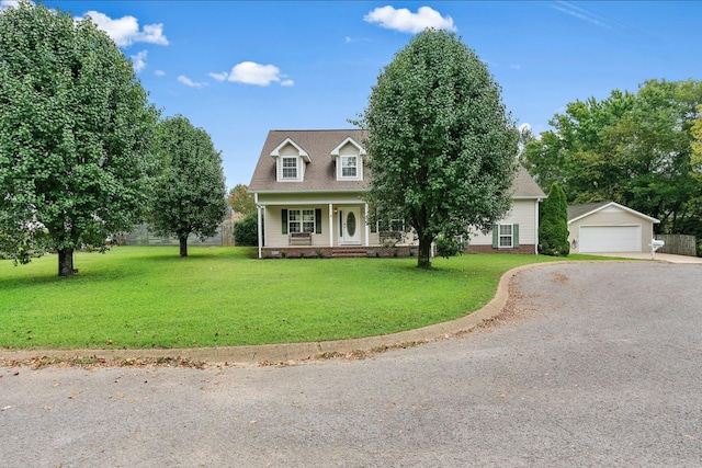 cape cod home featuring a garage, a front yard, an outbuilding, and a porch