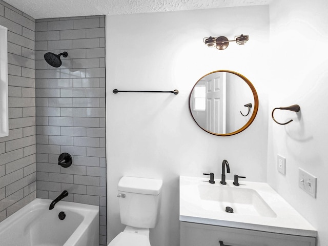 full bathroom with toilet, tiled shower / bath, vanity, and a textured ceiling