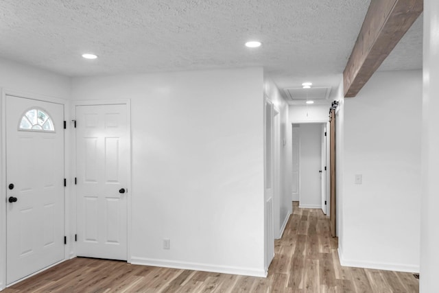 entrance foyer with a textured ceiling and light wood-type flooring