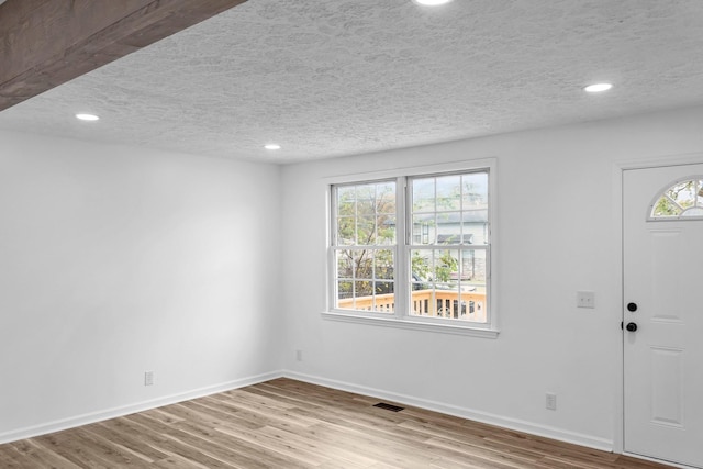 entryway featuring a textured ceiling and light wood-type flooring