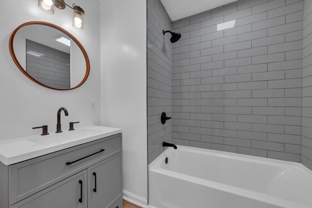 bathroom with tiled shower / bath and vanity