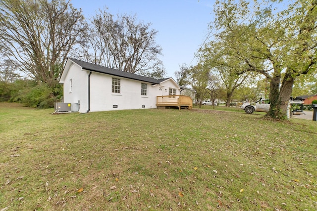 view of yard with central air condition unit and a wooden deck