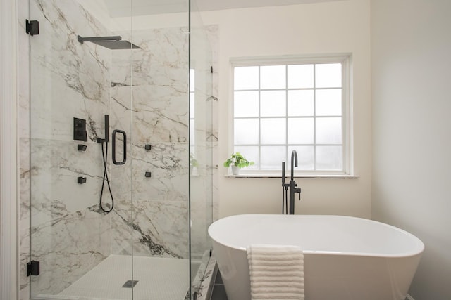 bathroom featuring separate shower and tub and a wealth of natural light