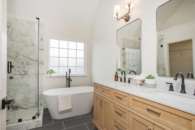 bathroom with tile patterned floors, vanity, lofted ceiling, and separate shower and tub