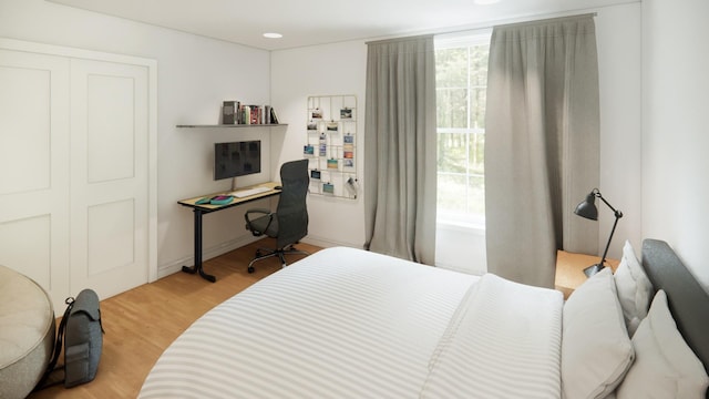 bedroom with light wood-type flooring and a closet