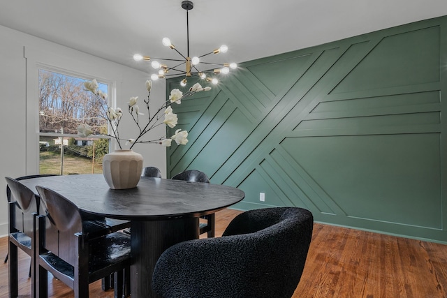 dining space featuring a chandelier and dark wood-style flooring