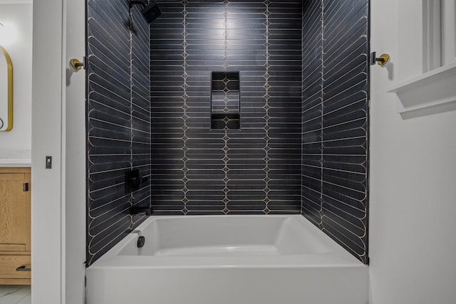 bathroom featuring shower / tub combination and vanity