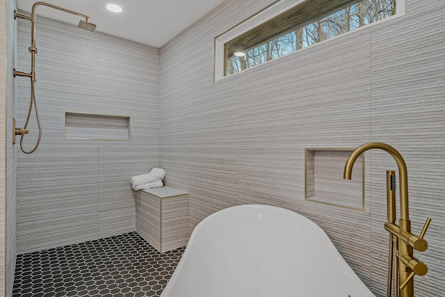 full bathroom featuring a freestanding tub and tiled shower