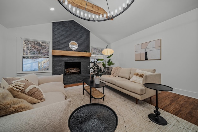 living area with light wood-type flooring, a brick fireplace, baseboards, and lofted ceiling