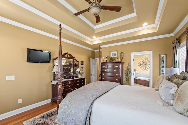 bedroom with ceiling fan, a tray ceiling, and crown molding