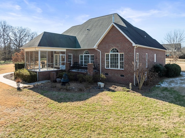 back of house with a sunroom, a yard, and a patio