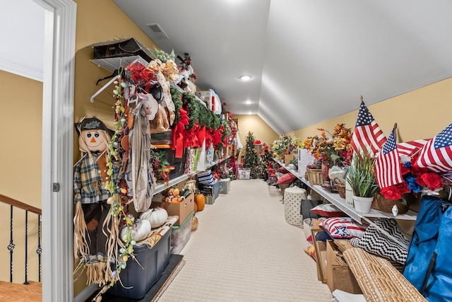 interior space featuring lofted ceiling and carpet flooring