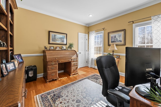 office featuring plenty of natural light, crown molding, and light wood-type flooring