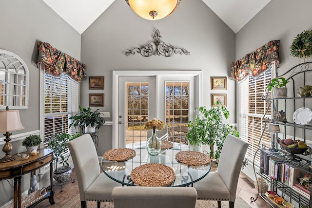 tiled dining room with lofted ceiling