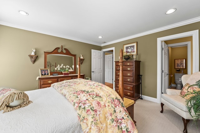 carpeted bedroom with ensuite bath and crown molding