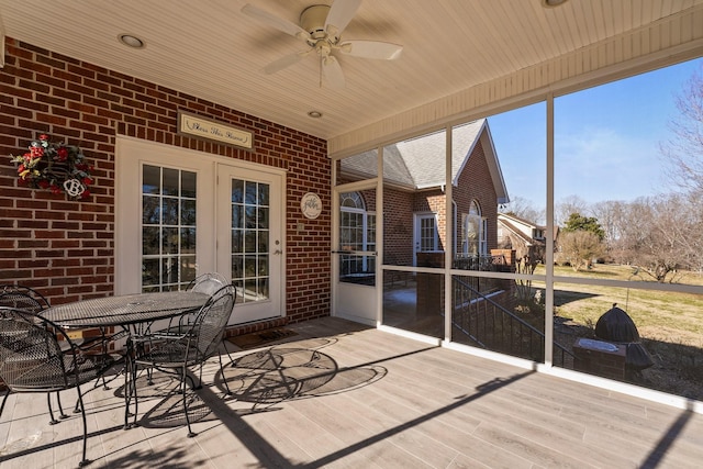 sunroom / solarium featuring ceiling fan, vaulted ceiling, and wood ceiling