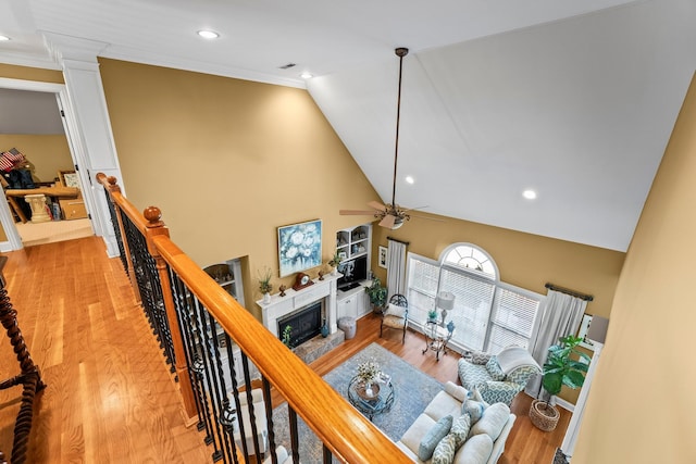 living room featuring lofted ceiling, ceiling fan, ornamental molding, and light hardwood / wood-style floors