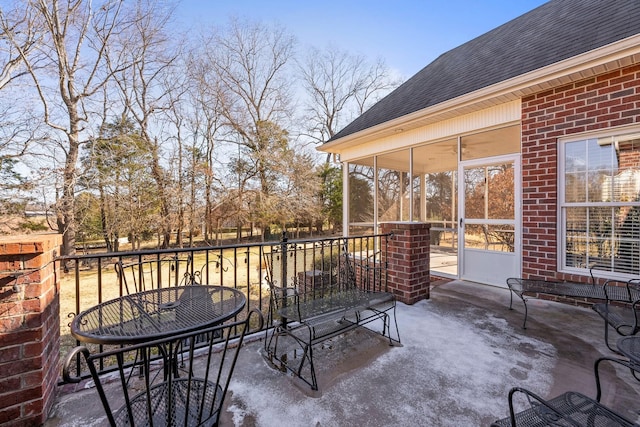 view of patio featuring a sunroom